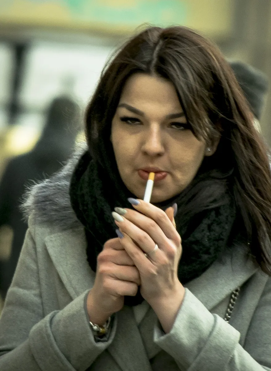 Young woman lighting a cigarette